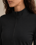 Close-up of the NORTHE Studio Form Jacket in Black, showing the half-zip neckline, fitted silhouette, and smooth fabric detail.