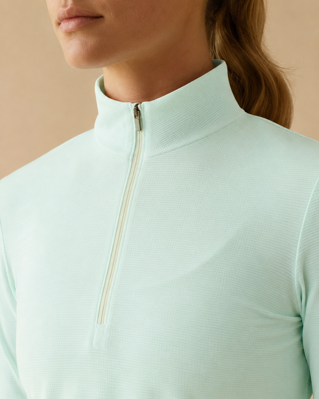 Close-up of the NORTHE Studio Form Jacket in Sage, showing the half-zip neckline and textured fabric detail.