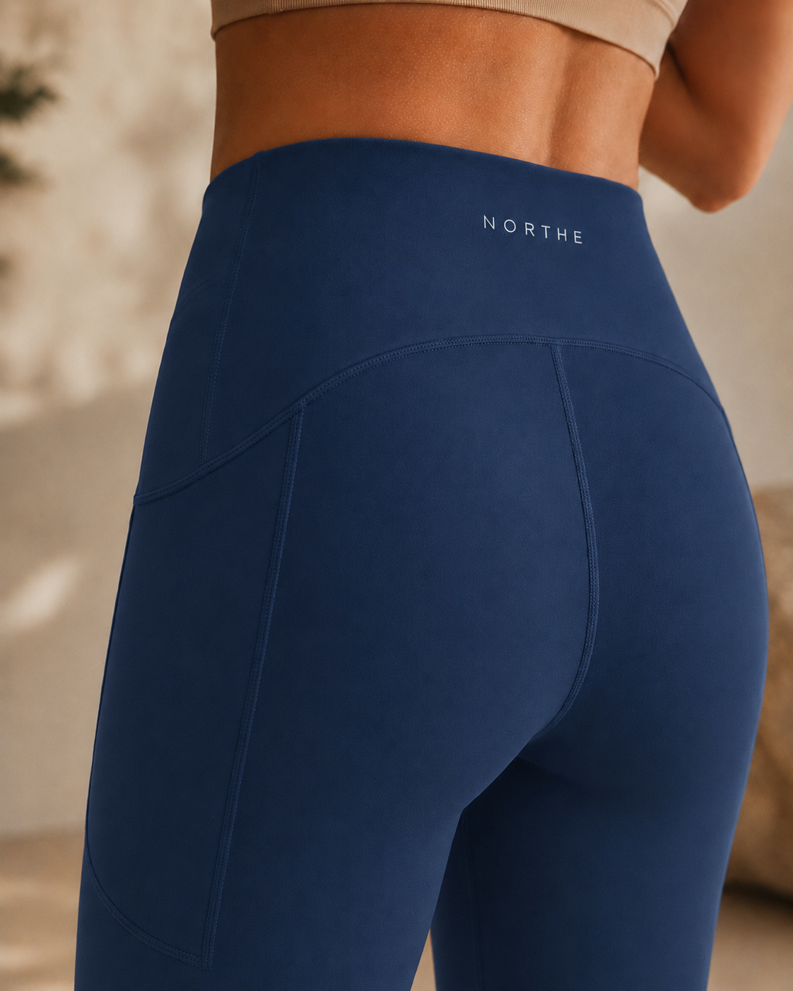 Close-up of the NORTHE Studio Sculpt Legging in Black, showing the high-rise waistband, back logo, and seam detail.